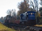 CSX 7131 leads a work train slowly along the line